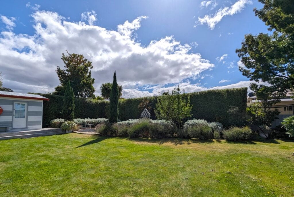 Freshly mowed lawn with beautifully maintained garden beds
