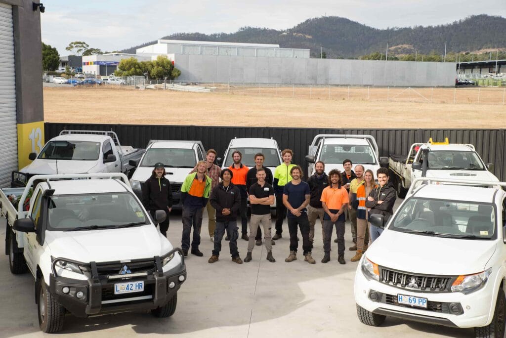 outdoor team photo with lawn squad vehicles and tools